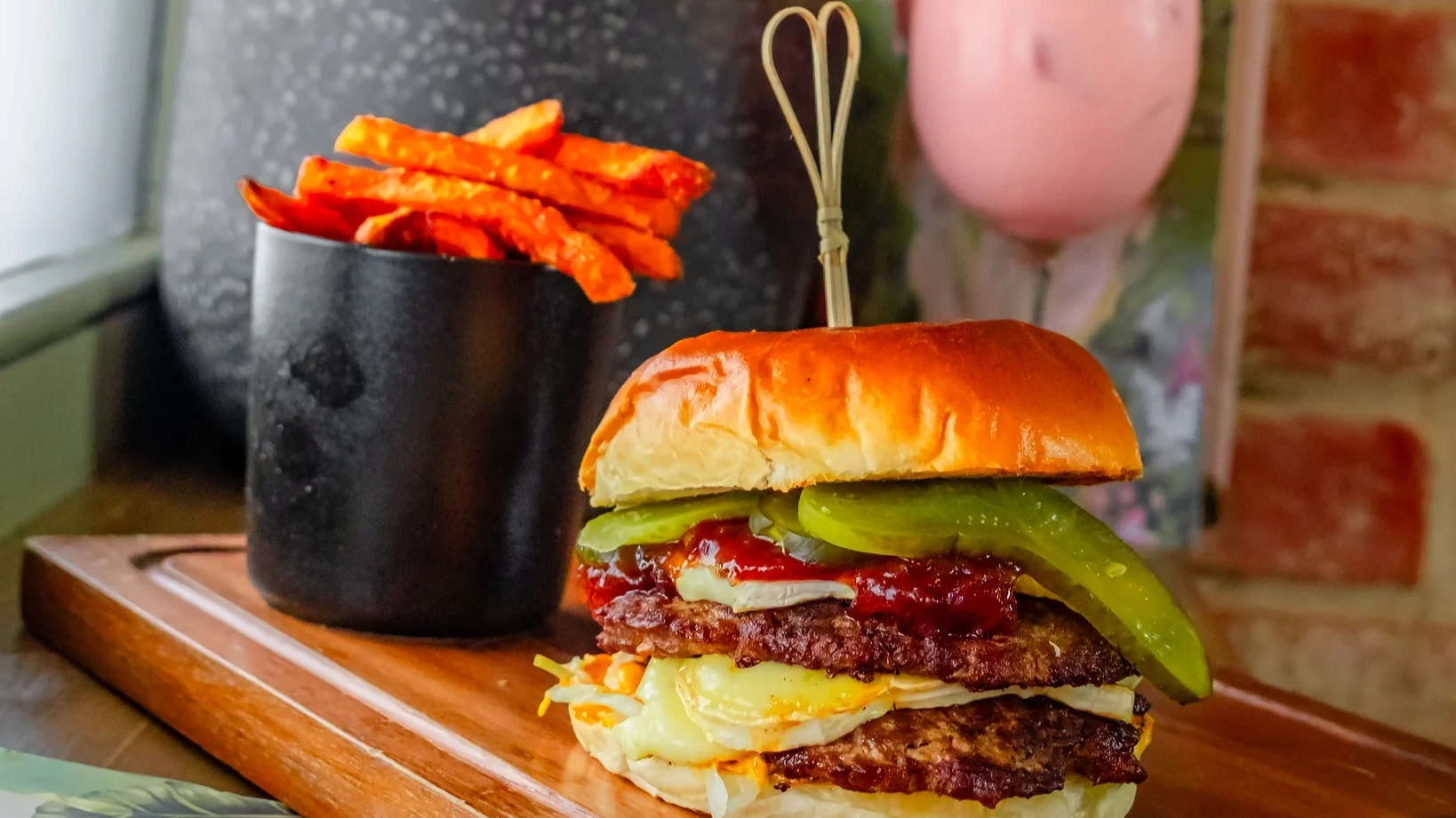 Al Bear burger with fries and a cocktail