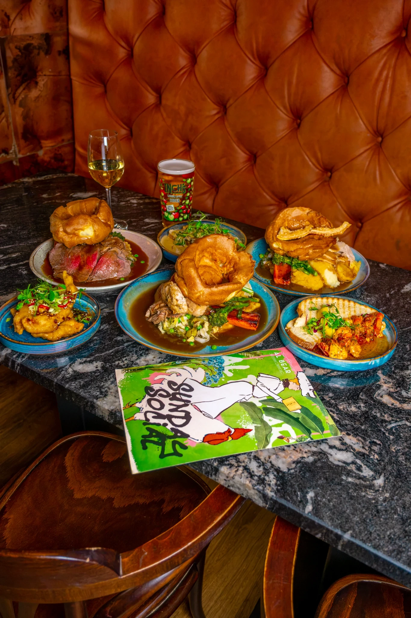Sunday roast dishes and sides spread across a table at Al Bear